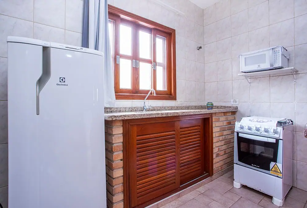 Apartment kitchen with a fridge, stove and microwave