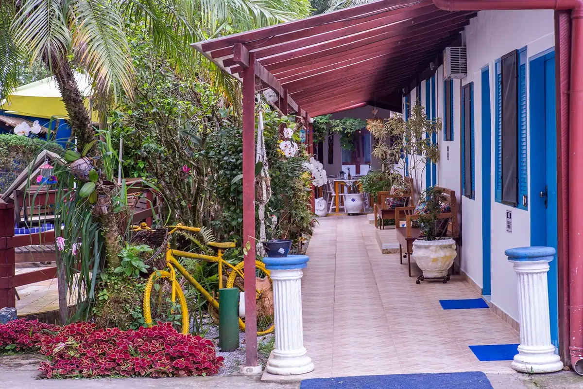 Flower-lined corridor of the inn with blue windows