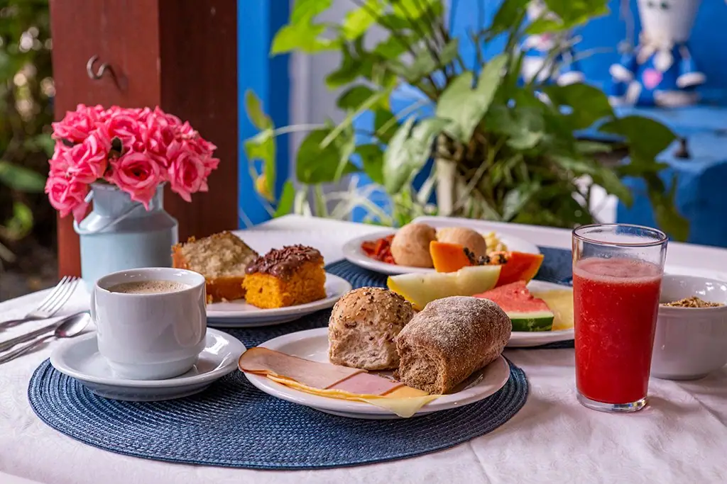 Breakfast table with bread, cake, fruit and juice