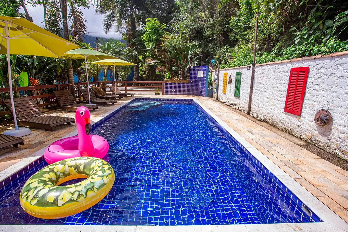 Pool with flamingo and donut floats and colorful windows