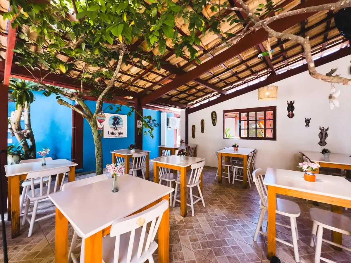 Breakfast room with wooden tables and blue windows