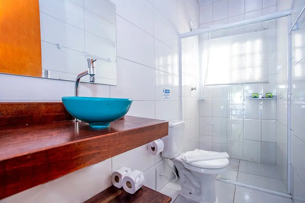 Deluxe Suite bathroom with a blue basin sink and shower