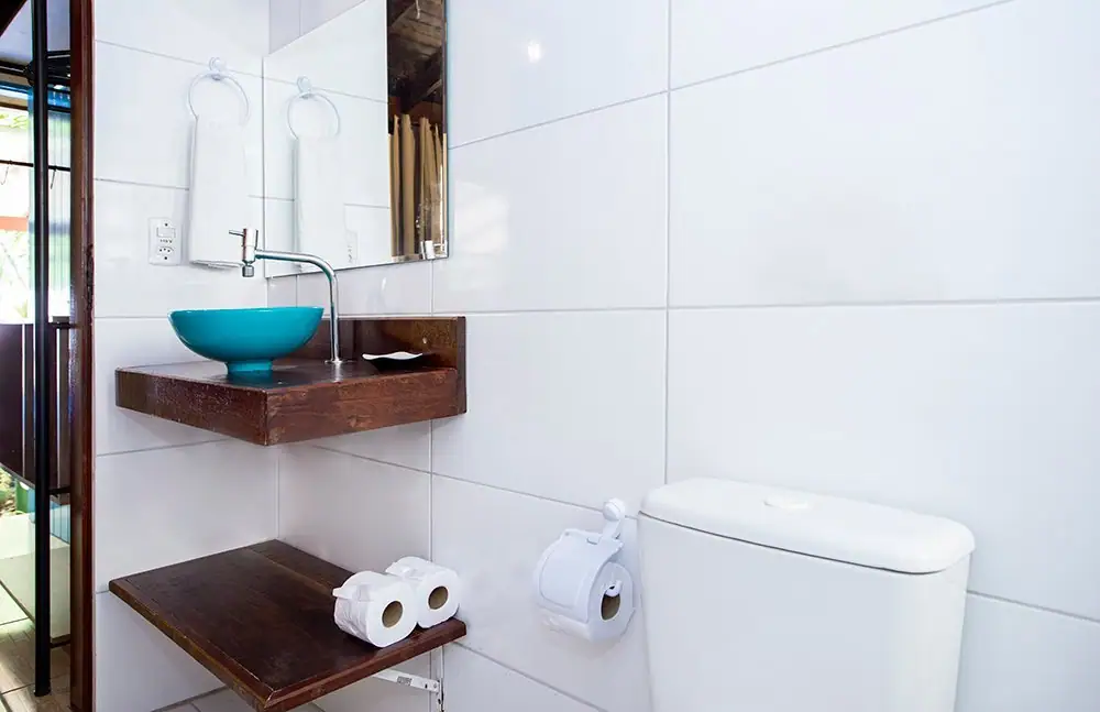 Blue basin sink and wooden countertop in the Deluxe Suite bathroom