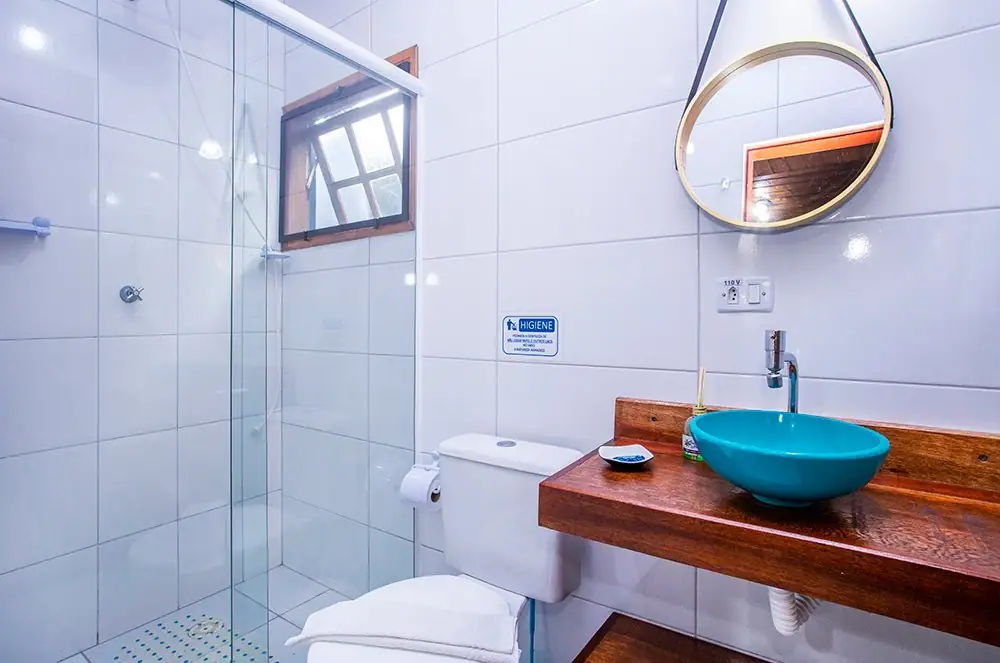 Economy Suite bathroom with a glass shower and a blue basin sink