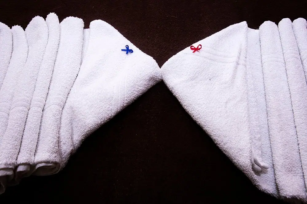 The inn's white towels on the bed